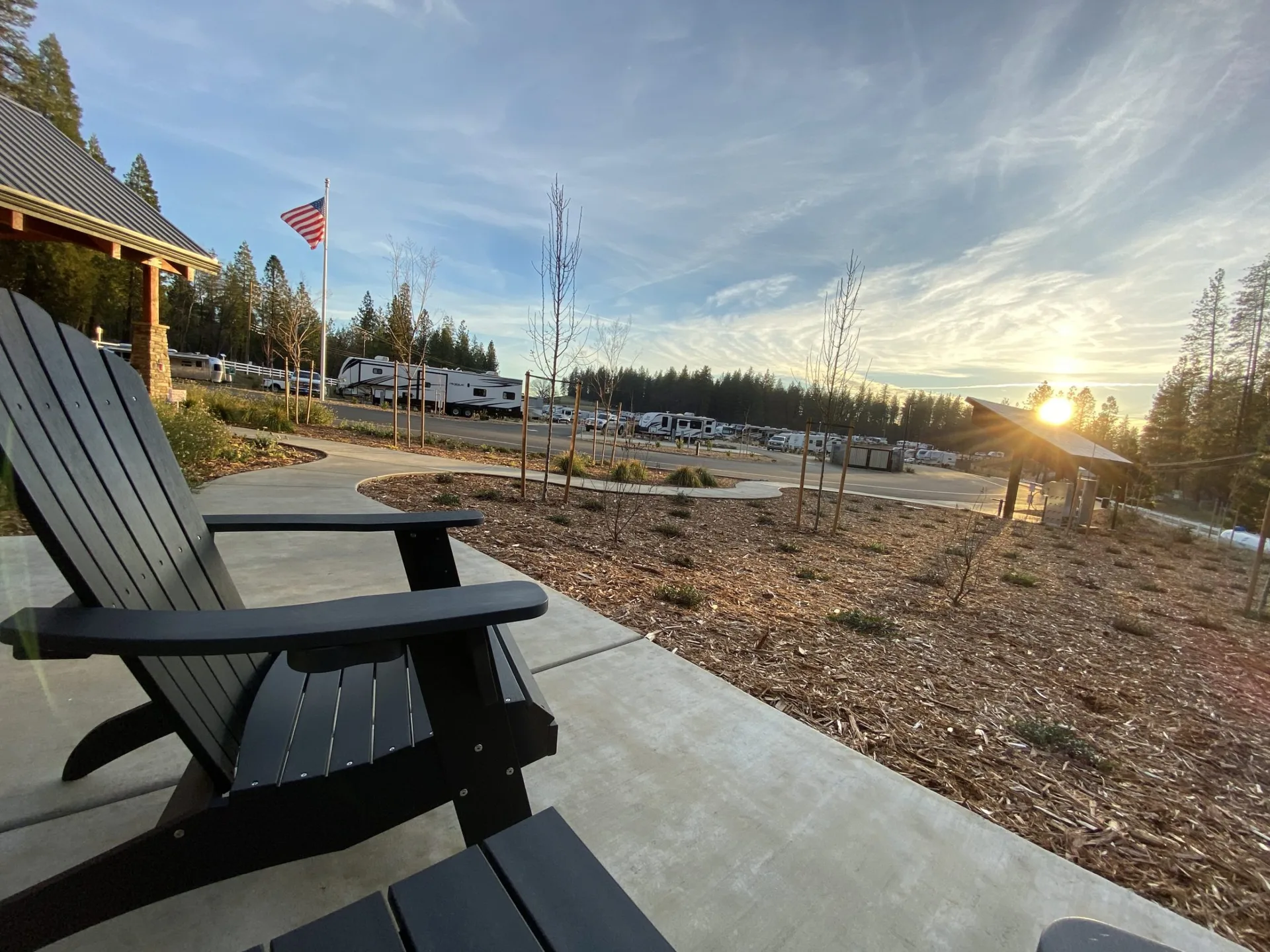 Adirondack chairs overlooking the RV sites at sunrise — Wi-Fi coverage reaches every corner of Grass Valley RV Resort