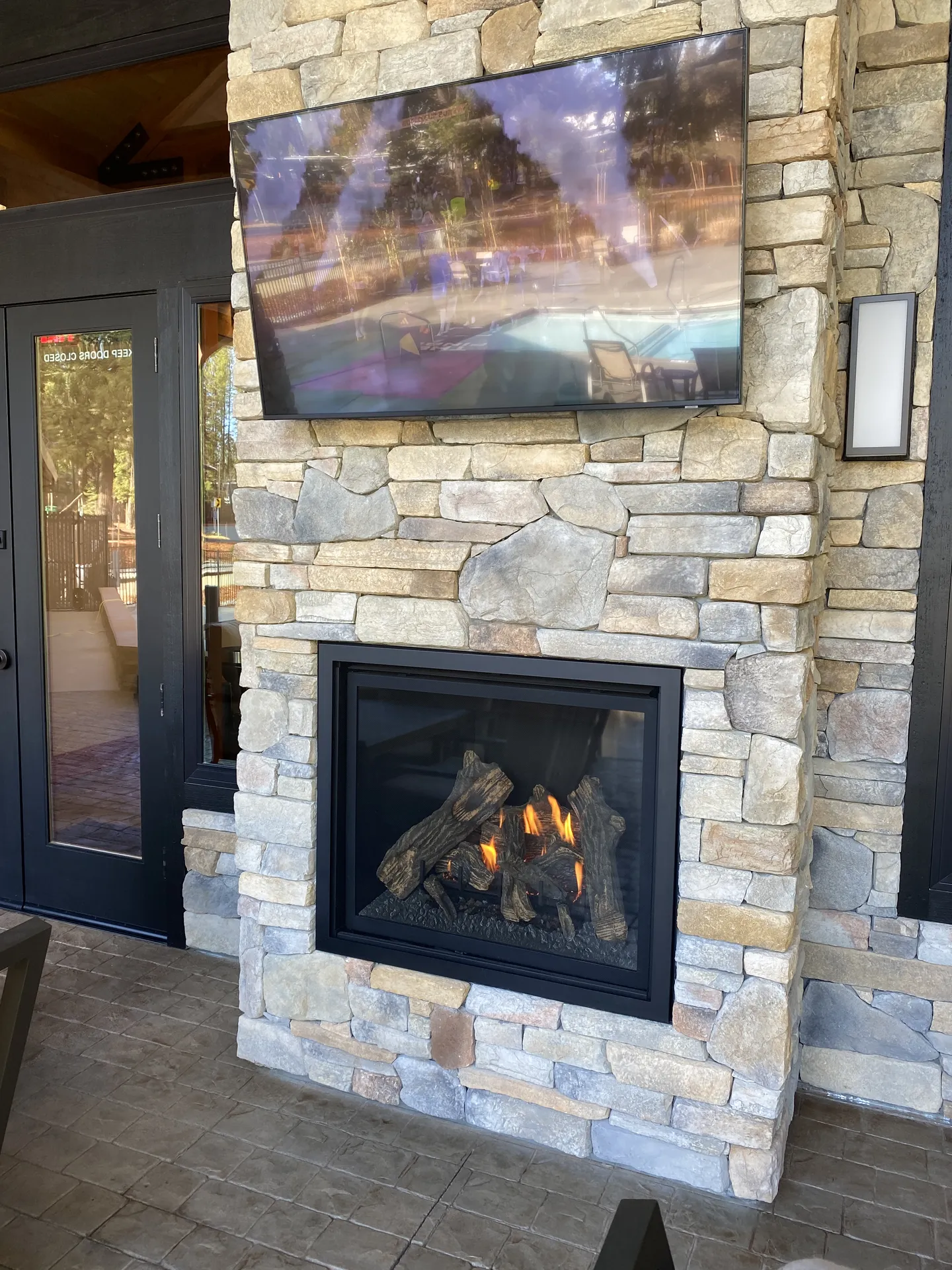 Outdoor fireplace lounge near the pool at Grass Valley RV Resort