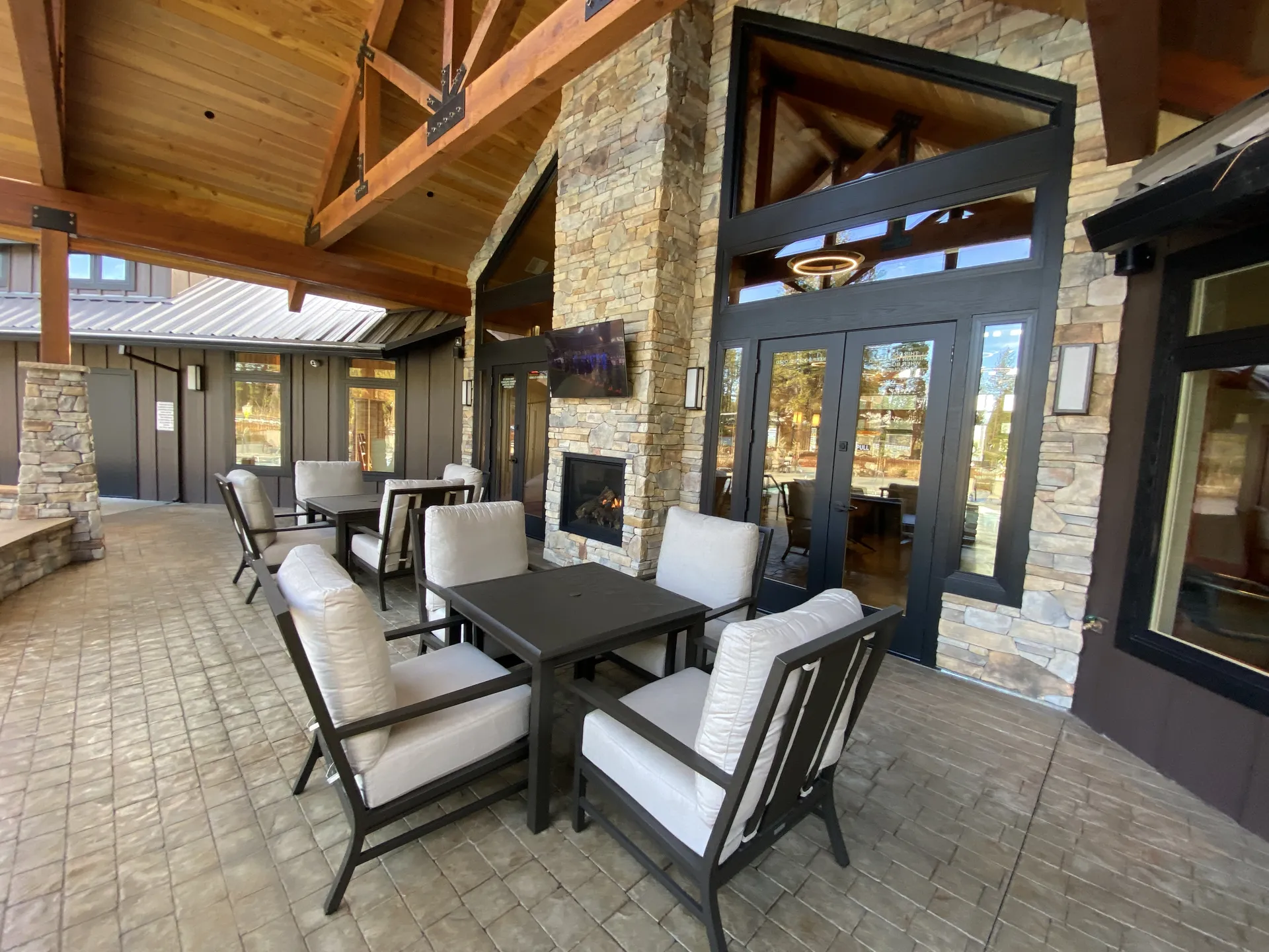 Shaded patio seating beside the pool at Grass Valley RV Resort