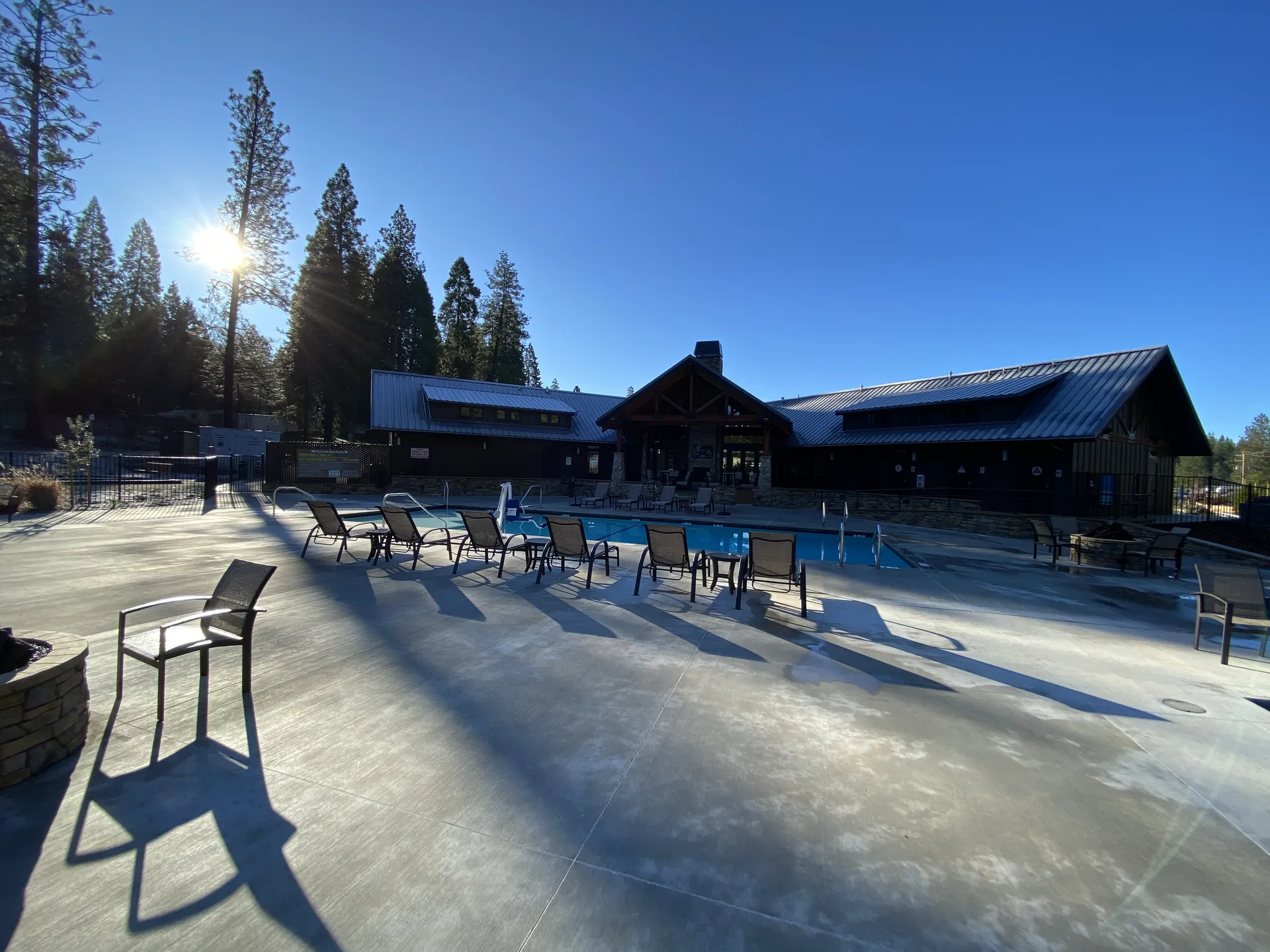 Pool deck seating in the morning light at Grass Valley RV Resort