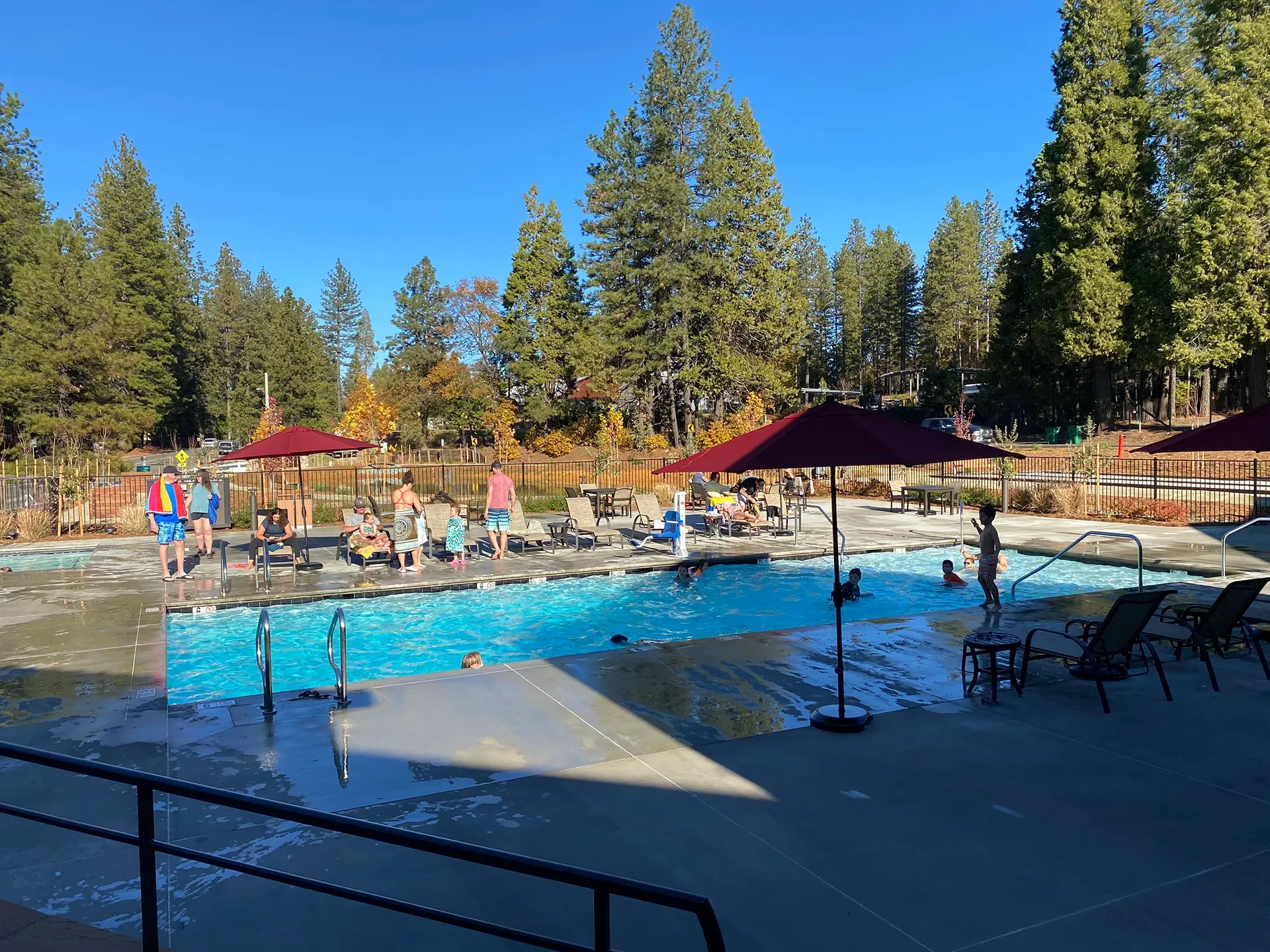 Guests enjoying the pool on a summer day at Grass Valley RV Resort