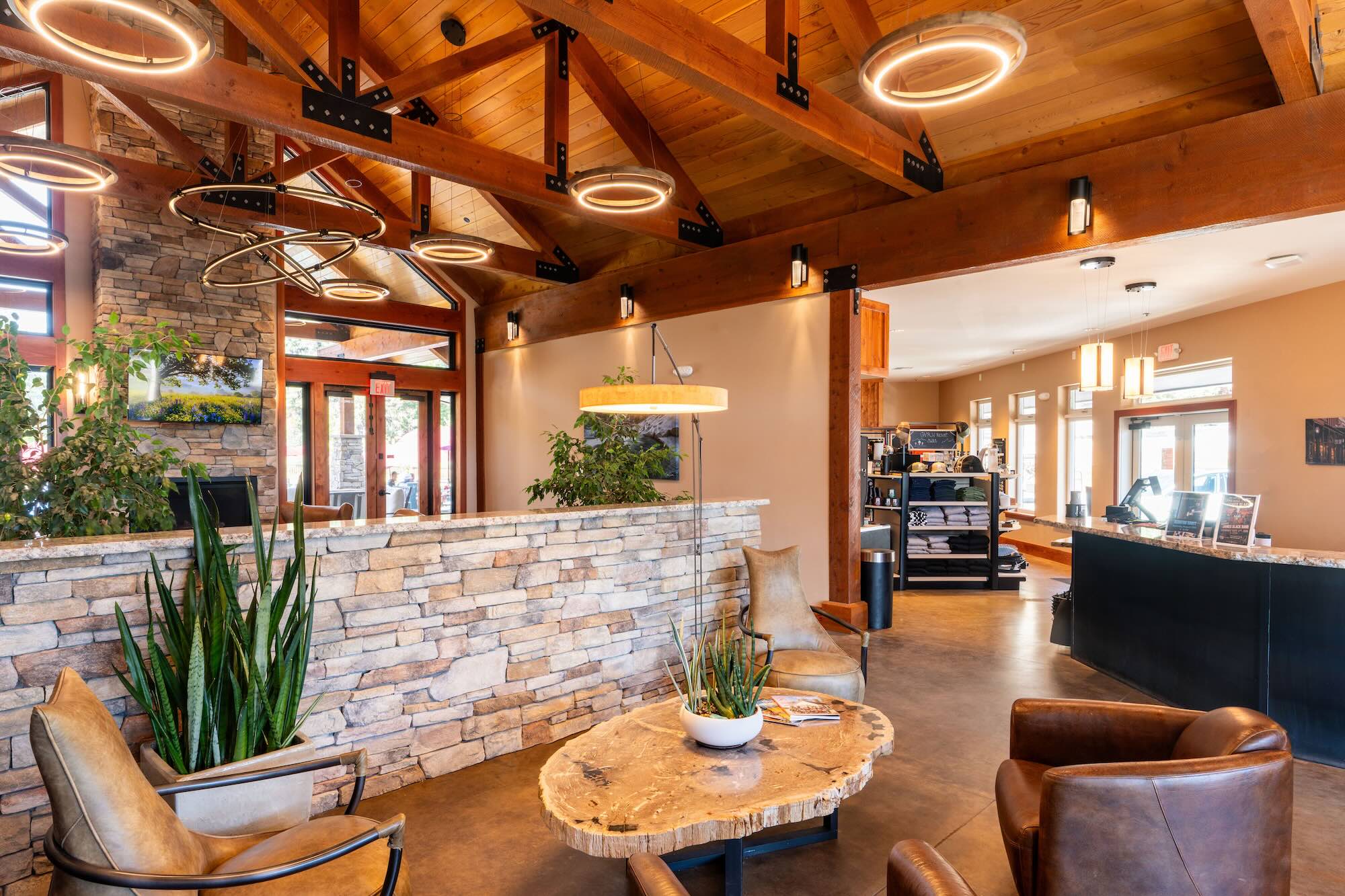 Lodge lobby with stone reception desk and timber ceiling