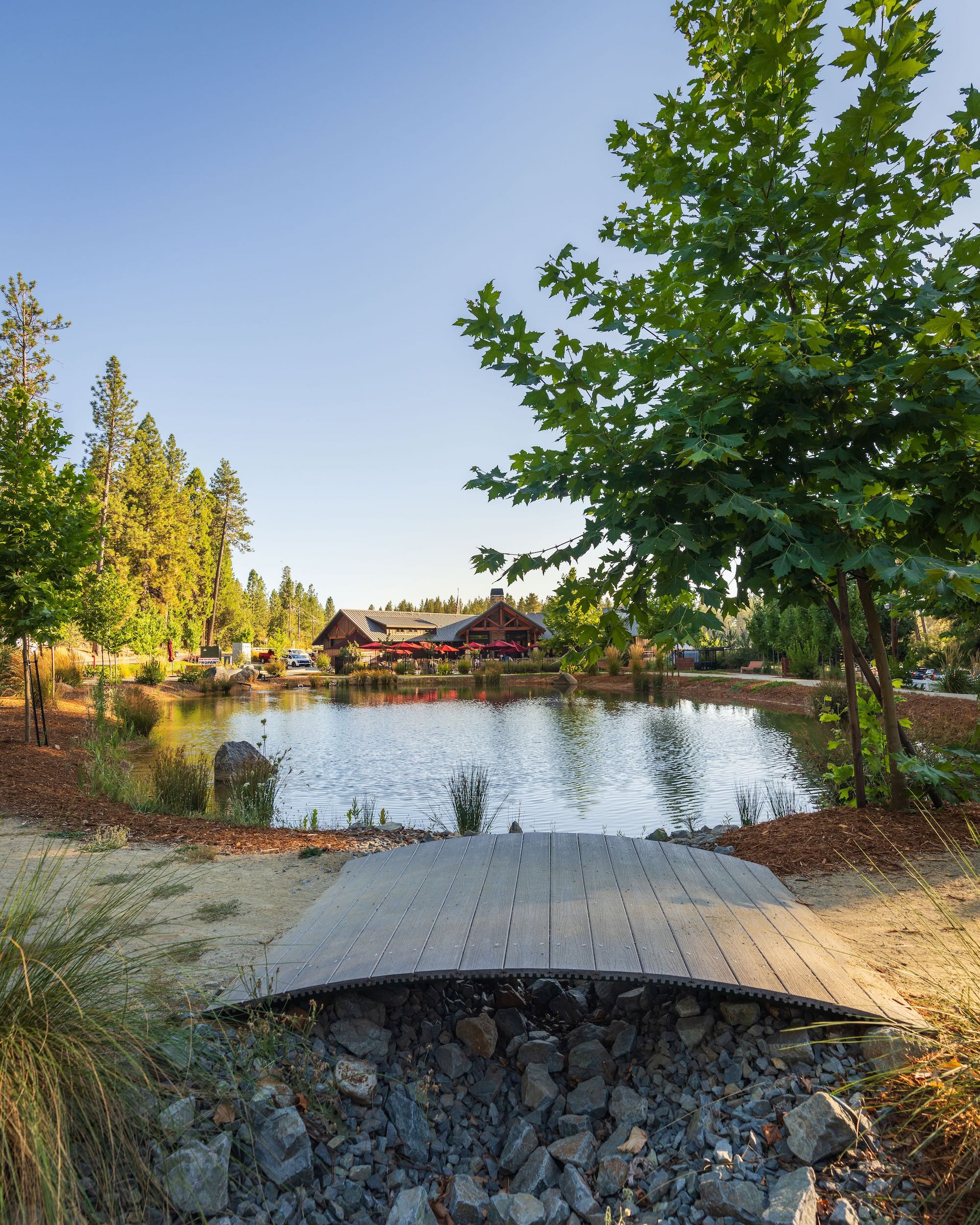 Pond and footbridge beside the lodge at Grass Valley RV Resort