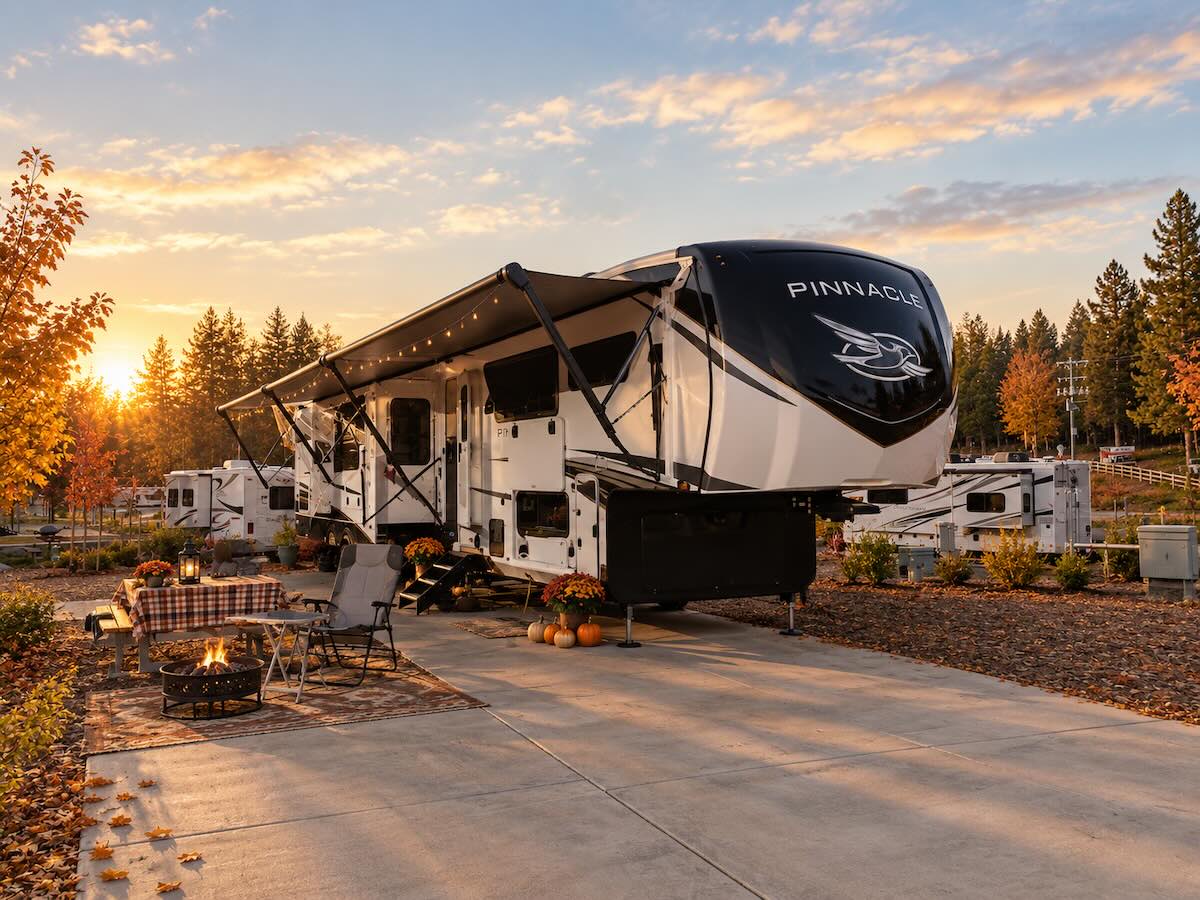 Fifth wheel RV parked on a paved full-hookup site in autumn at Grass Valley RV Resort